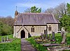 A small, single-storey, church with a porch and bellcote to the western end