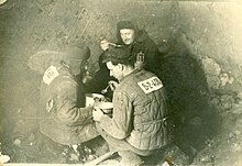 Political prisoners eating lunch in the Minlag "special camp" coal mine. In "special camps" prisoners had to wear prison garb with personal numbers. Political prisoners at Intalag, USSR.jpg