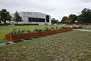 photo of lawn, landscape planters, and commemorative flowers