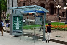 Some TTC shelters are equipped with displays that show when the next bus or streetcar will arrive, such as this one for 501 Queen. TTCStreetcarShelter.jpg