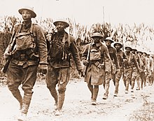 African-American soldiers of the U.S. Army marching northwest of Verdun, France 5 November 1918 USA infantry Verdun WWI.jpg