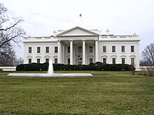 A north side view of the White House, showing the main building and the water feature in front of it