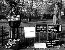 A man promoting Christian atheism at Speakers' Corner, London, in 2005. One of his placards reads "To follow Jesus, reject God." 2005-11-20 - United Kingdom - England - London - Hyde Park - Speakers' Corner 4887898959.jpg