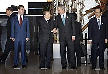 President Abdelaziz Bouteflika and George W. Bush exchange handshakes at the Windsor Hotel Toya Resort and Spa in Toyako Town, Abuta District, Hokkaido in 2008. With them are Dmitriy Medvedev, left, and Yasuo Fukuda, right. Abdelaziz Bouteflika and George W Bush 20080707.jpg