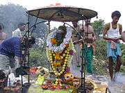 Reverence at the Agastya shrine atop the peak of Agastya mala, with garlands of fruits and flowers. Agathiyar.JPG