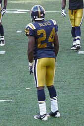 Cornerback Darrelle Revis wearing the New York Titans throwback uniform in 2008. This design combined the original shade of gold from 1960 with the 1961-62 striping modifications DarrelleRevis.JPG