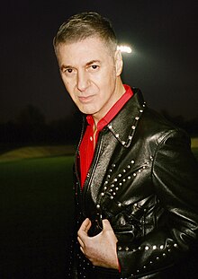 French actor and singer Etienne Daho wearing Americana-inspired black leather blouson and red western shirt in 2023. Etienne Daho 2023 (cropped).jpg