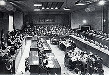 View of the Tribunal in session: the bench of judges is on the right, the defendants on the left, and the prosecutors in the back IMTFE court chamber.jpg