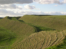 View of the ramparts of the hillfort of Maiden Castle (450 BC), as they look today Maiden Castle, Dorchester..jpg