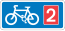 Rectangular, blue traffic sign with a white bicycle symbol and a red square with the number 2 in it.