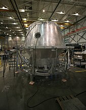 An early Dragon pressure vessel, photographed during factory tests in 2008. SpaceX factory Dragon capsule.jpg