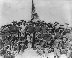 Colonel Roosevelt and the Rough Riders after capturing Kettle Hill in Cuba in July 1898, along with members of the 3rd Volunteers and the regular Army black 10th Cavalry TR San Juan Hill 1898.jpg