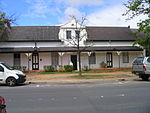 These two semi-detached cottages form part of a row of eight similar semi-detached cottages that were erected between 1817 and 1859 in the Cape Dutch style and that were later Victorianised. The cottages form an important visual element of the historical character of Dorp Street in Stellenbosch.
