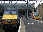 A National Express East Coast mk4 rake and a Virgin Trains Pendolino from the West Coast Main Line at Glasgow Central railway station in 2009