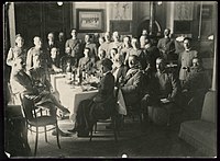 Helen Johns Kirtland seated at table with Italian military officers near Piave River, Itálie