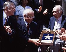 Johnny Grant, center, at the July 29, 1991 presentation ceremony for producer Joe Pasternak, on the right. At left is Gene Kelly. Joe Pasternak Allan Warren.jpg