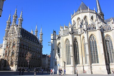 Le chevet et l'hôtel de ville de Louvain à gauche.