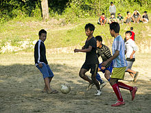 Physical exercise is one recommended way to manage mild depression. Soccer football informal in Manipur India cropped.jpg