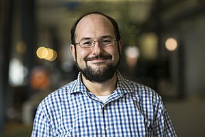 Photograph of Gregory Varnum smiling in January 2016