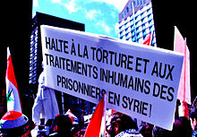 Demonstration in Montreal in solidarity with the people of Syria. The sign reads: "Stop torture and inhumane treatment of prisoners in Syria!" (5) Montreal Syrian solidarity demonstration March 27.jpg