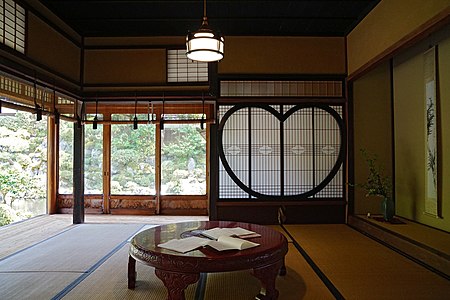 Sukiya style, early 20th century. Garasu-do, sudare, shōji, and plaster walls are visible. The garasu-do use large single glass panes, which would have been extremely expensive before float glass became available in the 1960s.