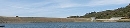 A photo of the Anderson Dam in Santa Clara County, California, viewed across Anderson Lake in 2014.