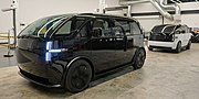 Two Canoo Lifestyle Vehicles on a factory floor.