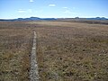 By late September the alpine flora on the plateau have turned brown. The distant peaks are part of the Flat Tops range.