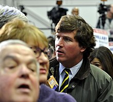 Carlson working as a Fox News correspondent at a Hillary Clinton campaign rally at Manchester Community College in 2016 Hillary Mnchstr0640 Fox in the hen house (24959448851).jpg