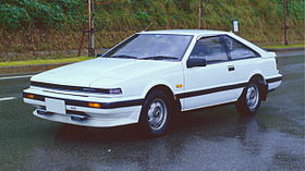 Front-three-quarter view of a three-door car with pop-up headlights and door mirrors