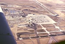 Looking north, January 1966. Runway 35 became 35L, after 35R was built. The old United Airlines pilot training center buildings, on the airport proper, were still in operation. A UAL DC-8 pilot training flight has just made a missed approach, complete with its shadow. Jan1966-StapletonAirport-SouthToNorthView.jpg