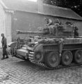 Wounded German soldiers ferried to first aid post on a Cromwell tank, 3 September 1944