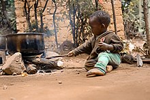 An infant from Uganda playing with stoves Umwotsi.jpg