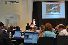 U.S. Federal Emergency Management Agency (FEMA) Administrator W. Craig Fugate speaking at a Red Cross seminar on using social media during natural disasters. GIS has an integral role to play in such agendas. FEMA - 44996 - FEMA Administrator W. Craig Fugate speaking on using social media.jpg