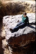 A woman sitting on the meteorite in 1967