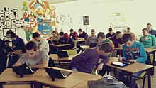 Students learning how to edit a Wikipedia article on a tablet computer