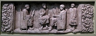 A teacher with two students, as a third arrives with his loculus, a writing case Roman school.jpg