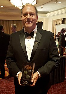 William Ledbetter holding the Nebula Award he won for his novelette "The Long Fall Up."