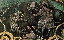 A horse-rider fighting a tiger, depicted on a gilded mirror discovered in Jincun, Luoyang. Zhan Guo Jin Yin Cuo Shou Xi Wen Jing He Nan Luo Yang Jin Cun .jpg