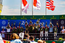 The overall winners on the podium, holding up their trophies