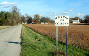 Looking east toward Colburn along County Road 700 North. Welcome sign made by Bill Fitzmaurice, a resident of Colburn for 25 years.