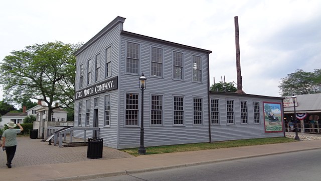 A grey-colored, wooden factory building