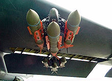 Three GBU-31 JDAM precision guided bombs on a triple-ejector rack, under the wing of a B-52