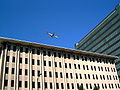 A passenger jet flying over Downtown San Jose, CA