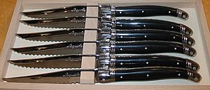 a set of black Laguiole steak knives