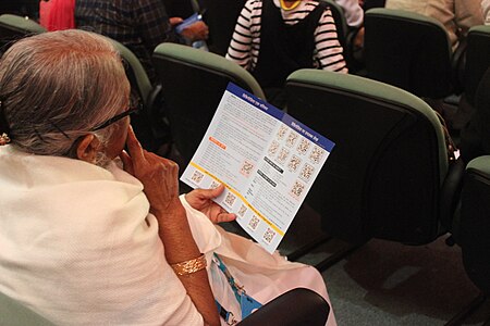 Participants and delegates reading Wikipedia pamphlet
