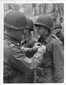 Major General Leland Hobbs presents the Silver Star to Second Lieutenant Robert F. Ackerman of Springfield, Massachusetts, May 2, 1945