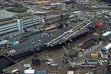 America in dry dock at Norfolk Naval Shipyard, 1982. USS America (CV-66) in dry dock at the Norfolk Naval Shipyard on 1 June 1982 (6383910).jpg