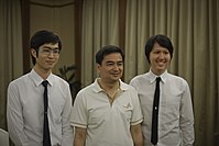 Chulalongkorn students wearing male university uniforms with former Prime Minister Abhisit Vejjajiva.