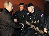 Member of Alpha Group, Russian Federal Security Service (right) shown with an AK-105 Kalashnikov rifle fitted with a LA-5/PEQ to the top of hand guard.